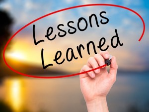 Man Hand writing Lessons Learned with br on visual screen.